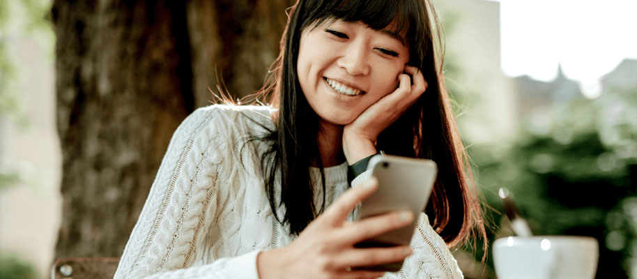 Woman looking at her cell phone with her eyes