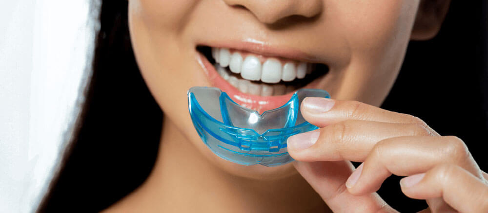 Woman using mouth guard