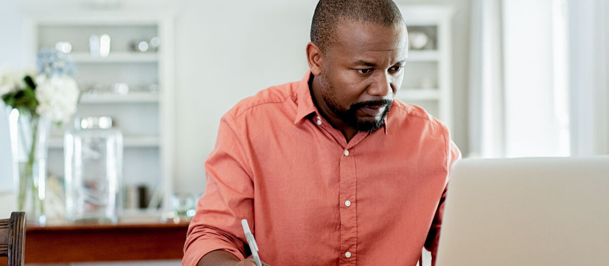 man looking intently at laptop