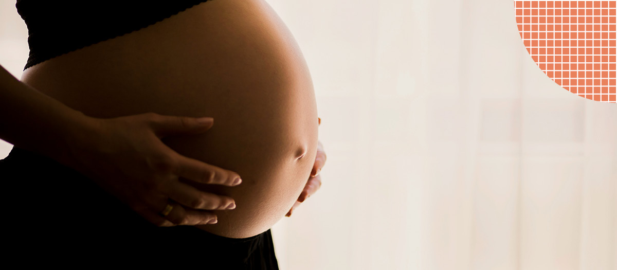 Pregnant woman holding stomach