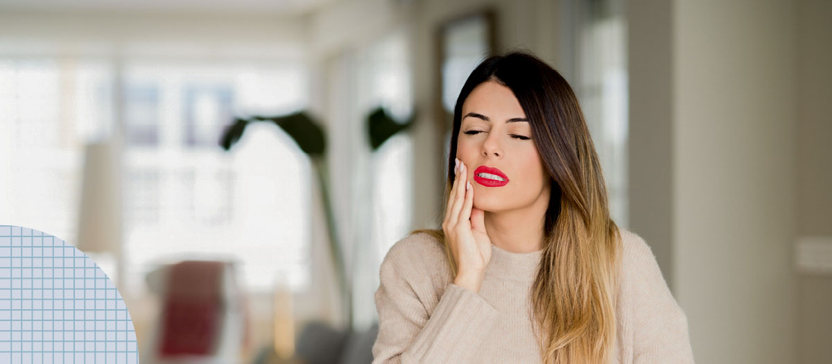 Woman holding her mouth in pain