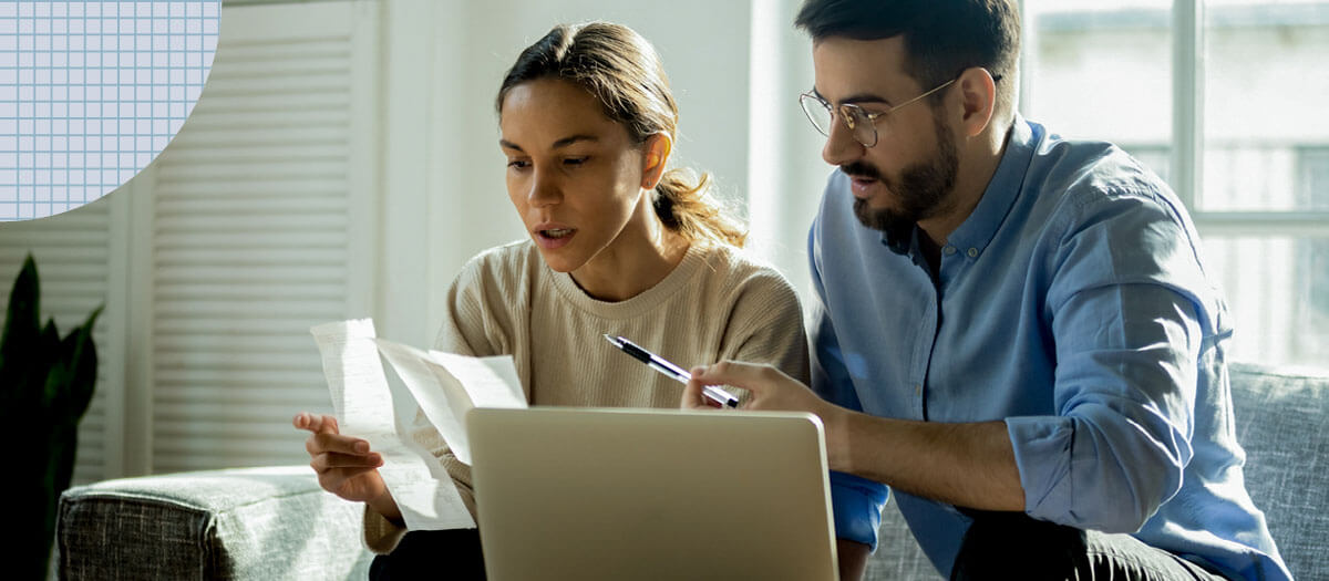 Man and woman looking at open enrollment documents