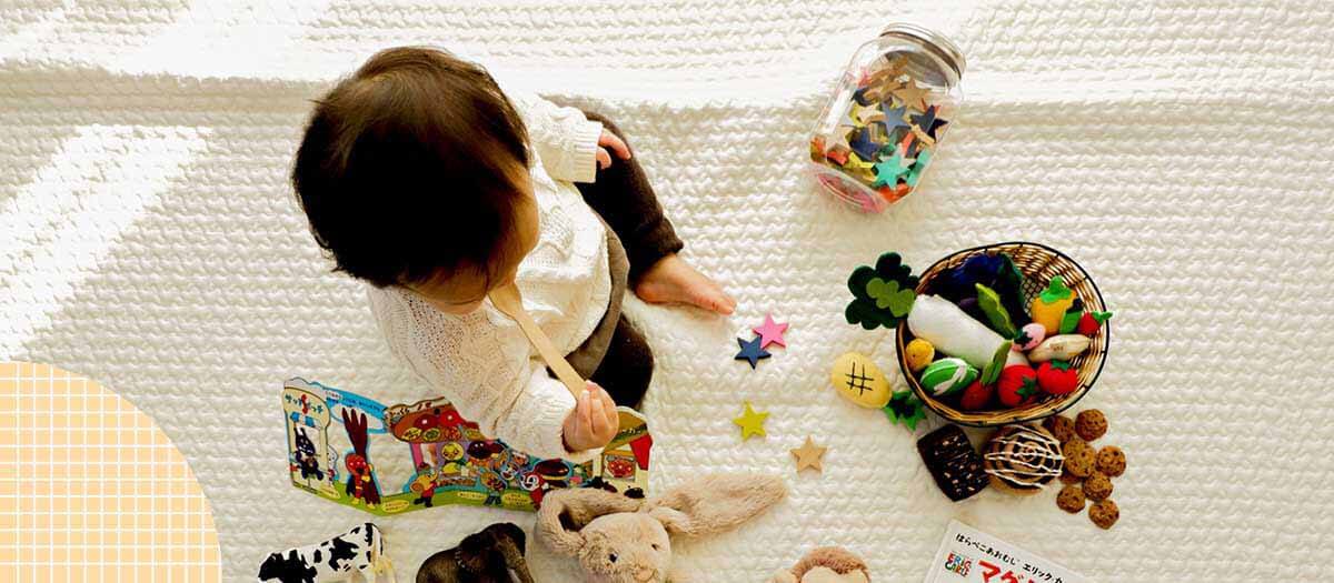 Child playing on floor with toys