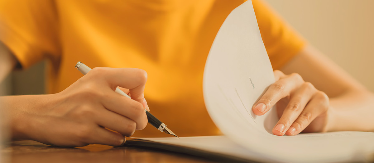 Person writing down dental information