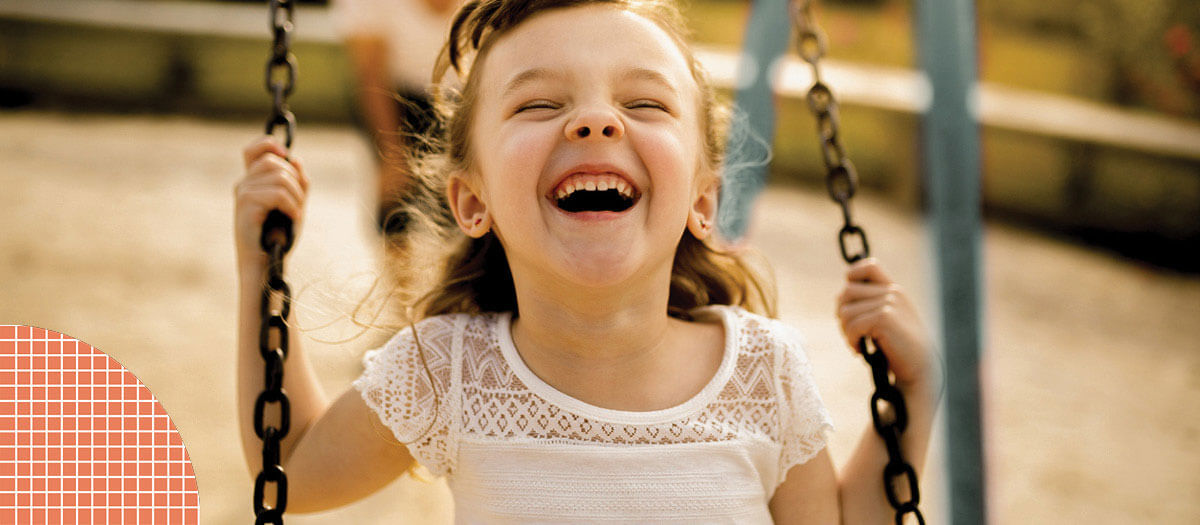 Girl smiling on swings