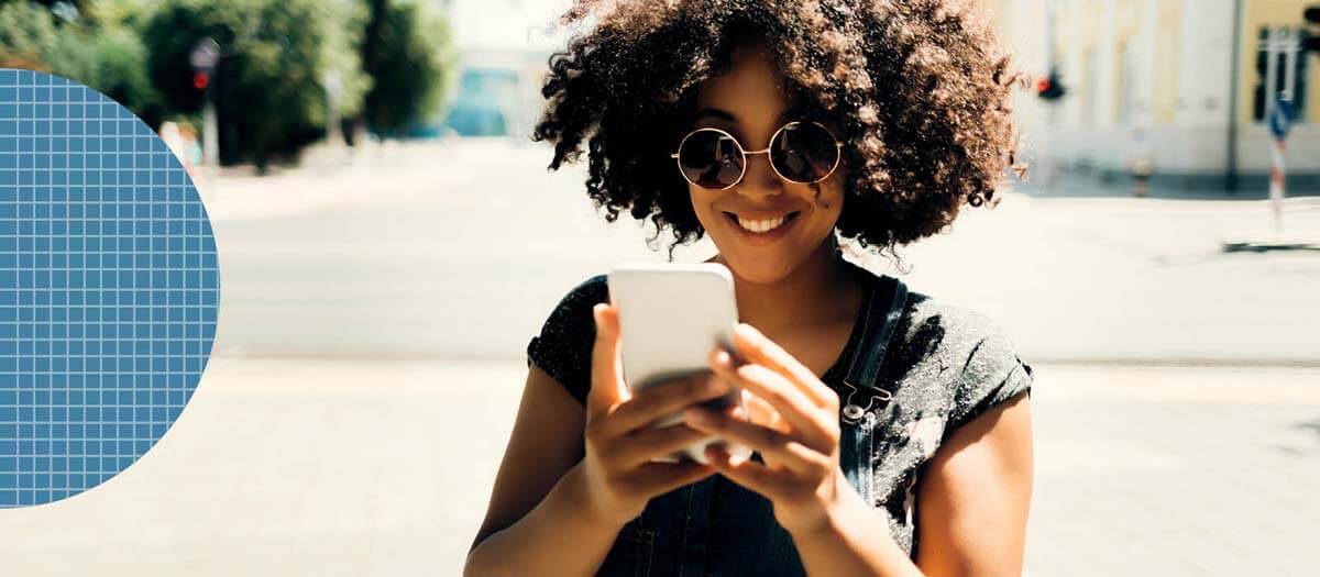 Girl looking at her phone while walking outside