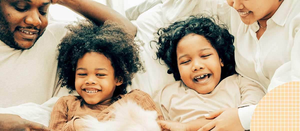 Two kids and parents laughing and smiling