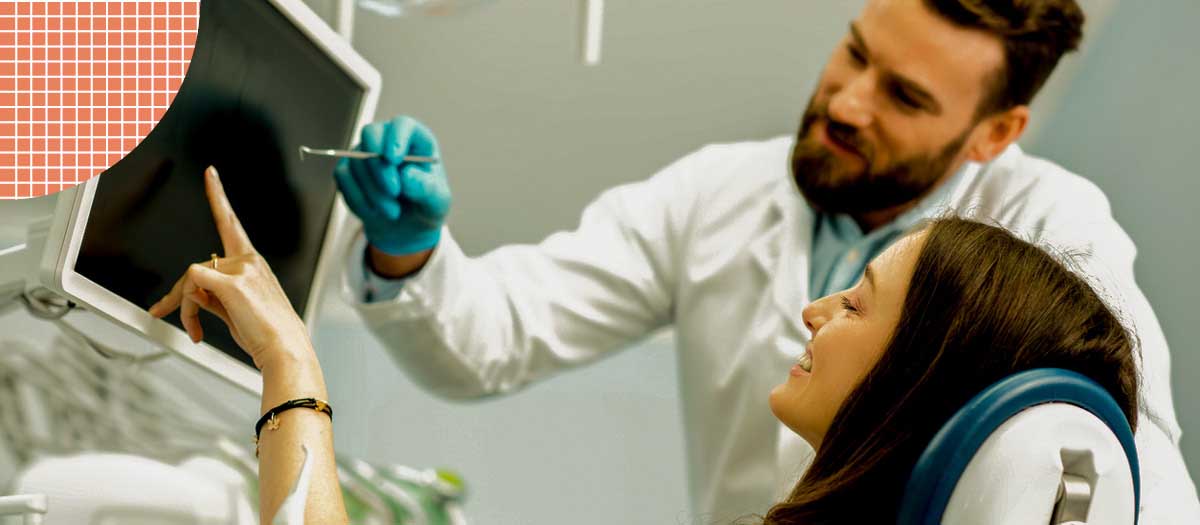 Woman and dentist looking at x-rays