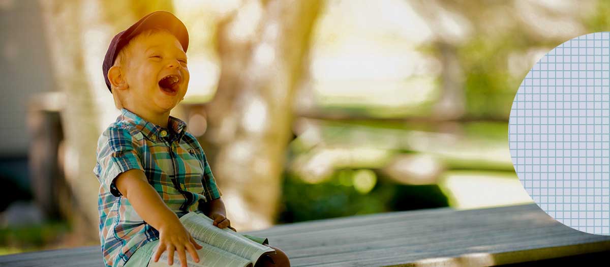 Child sitting on bench laughing