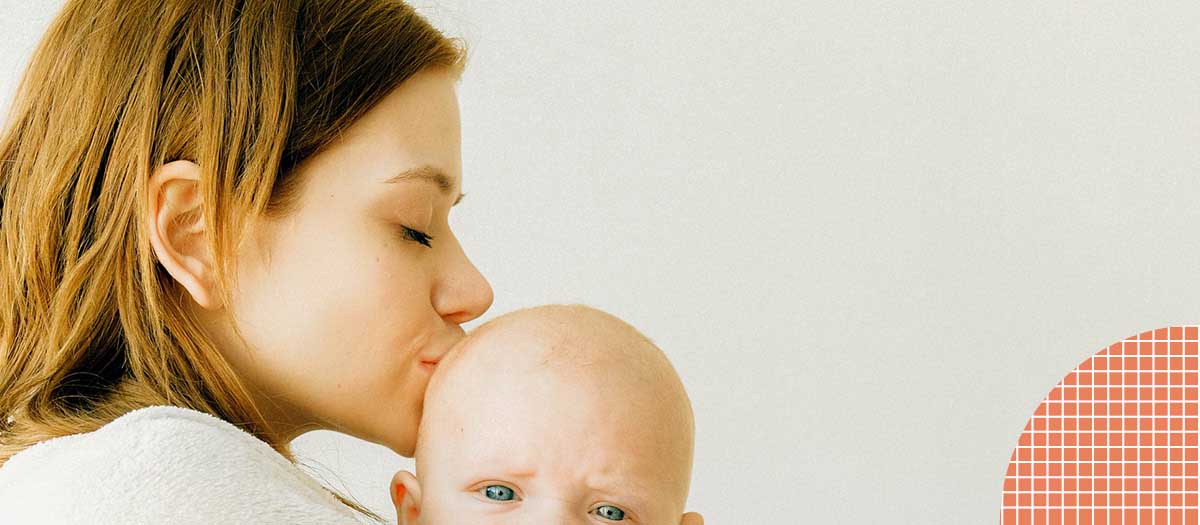 Mother kissing baby's head