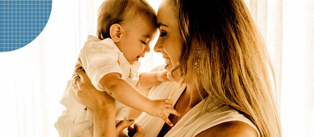 Woman holding smiling baby