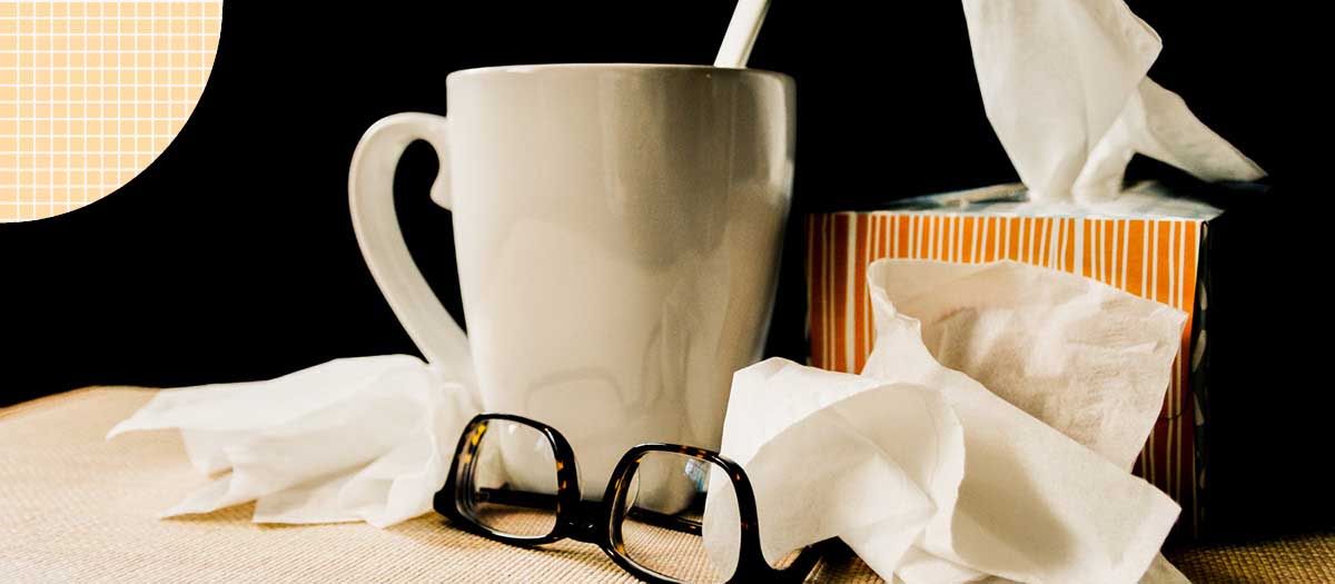 Tissues and cup of tea on bedside table