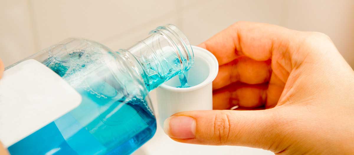 Mouthwash being poured into a cup