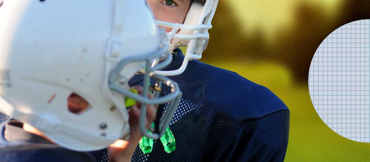 Two boys with mouthguards playing football