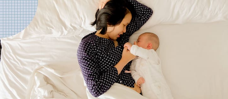 Woman laying in bed with her baby