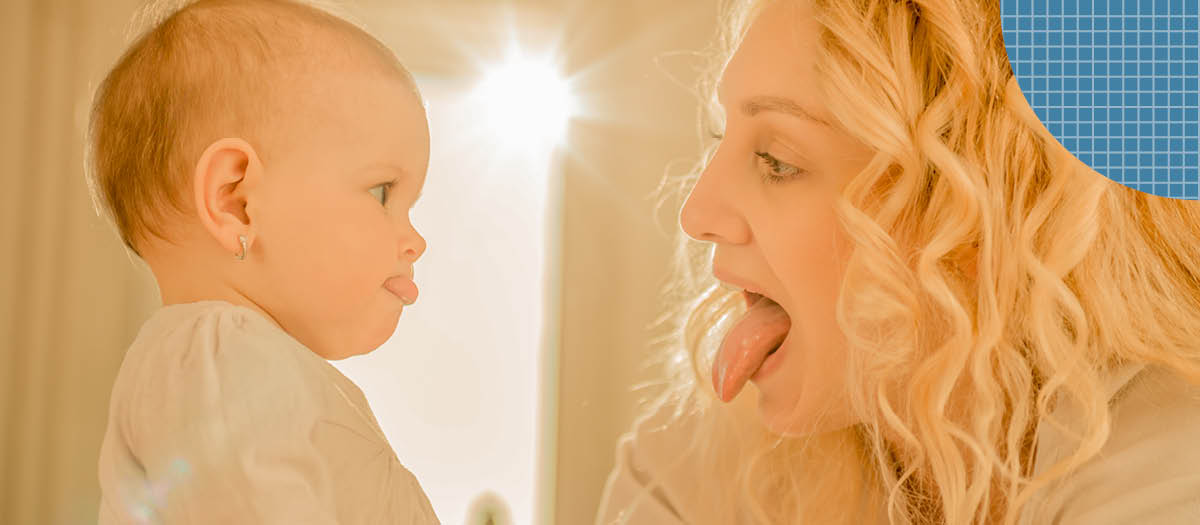 Mom and child sticking their tongues out at each other