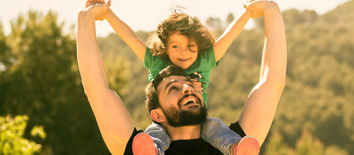 Dad with son sitting on his shoulders