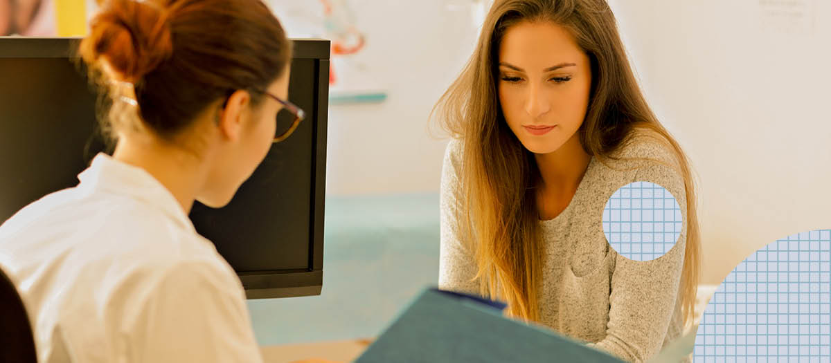 Doctor giving female patient information at table