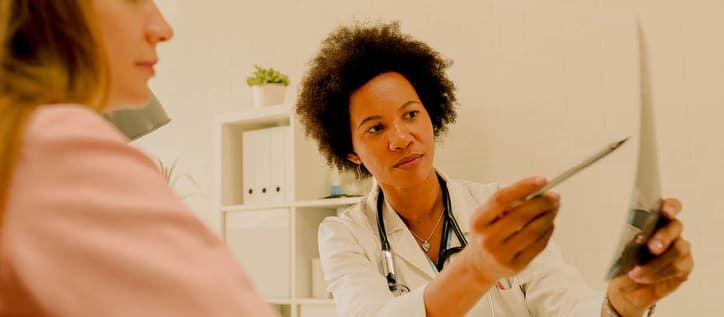 Doctor showing health documents to patient