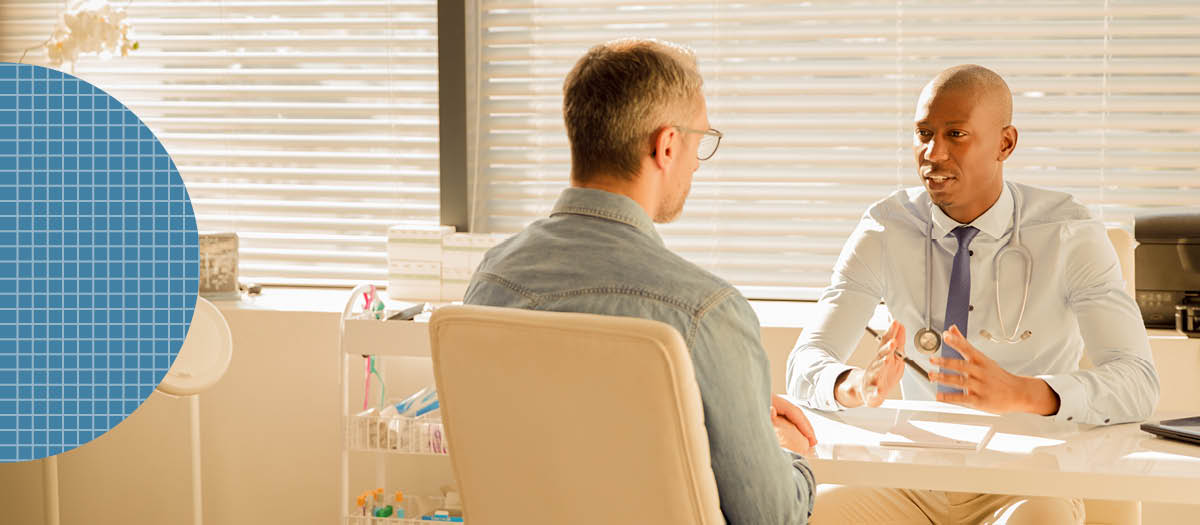 Doctor talking to male patient at a table 