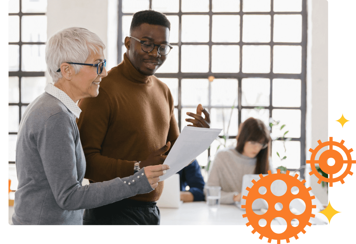 A diverse group of smiling professionals looking across a table overlayed with gears.