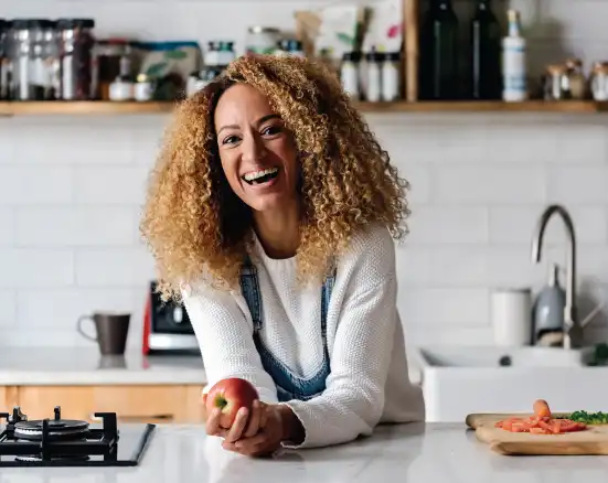 Middle age woman smiling in her kitchen