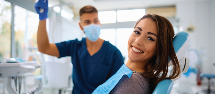 Young woman in a chair at the dentist getting an exam