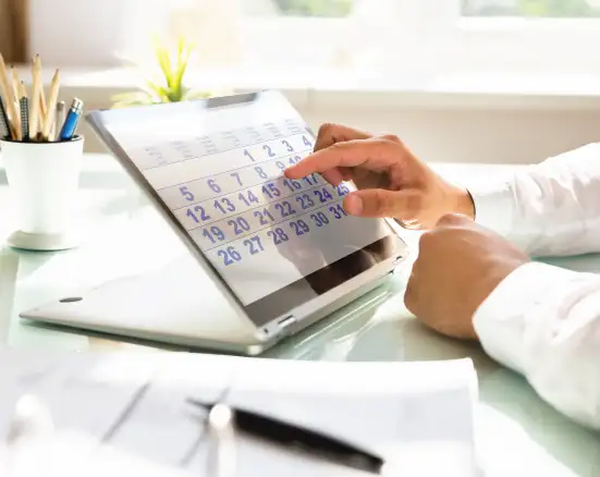 Pointing to a calendar as someone schedules a dental appointment.