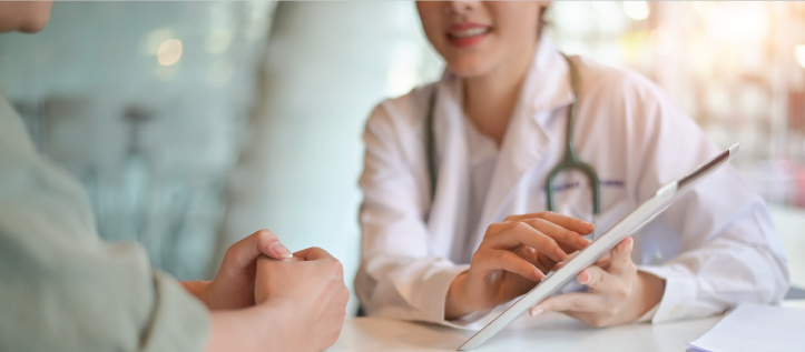 A dentist going over amalgam fillings with their patient on a tablet