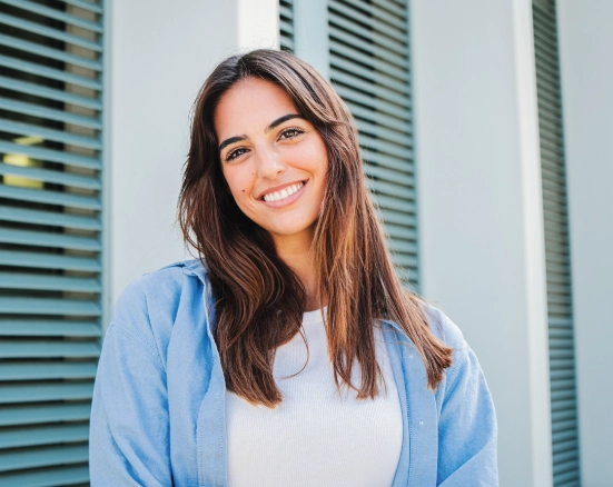 Young woman smiling outside