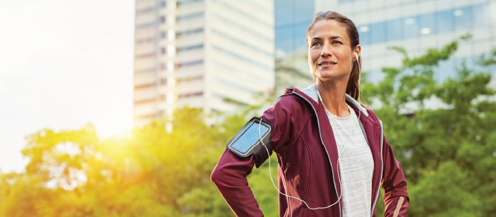 Woman smiling on a run outdoors