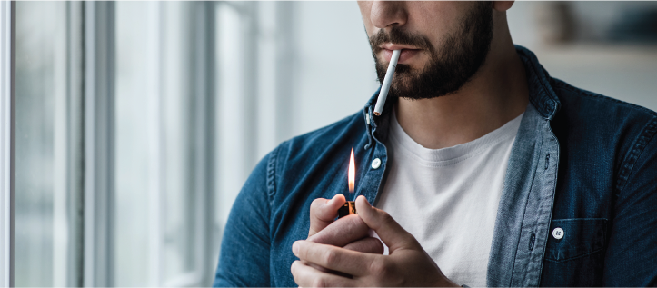 A man lighting a cigarette