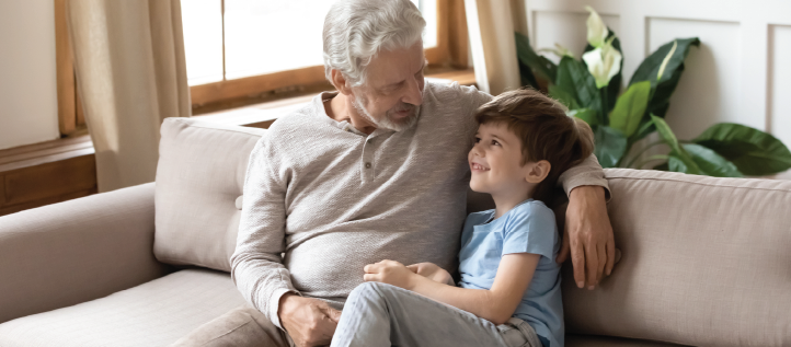 A young child playing with his grandfather.