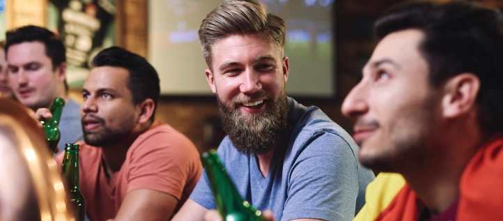 Friends enjoying themselves at a bar watching sports