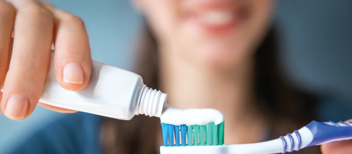 Placing toothpaste on a toothbrush