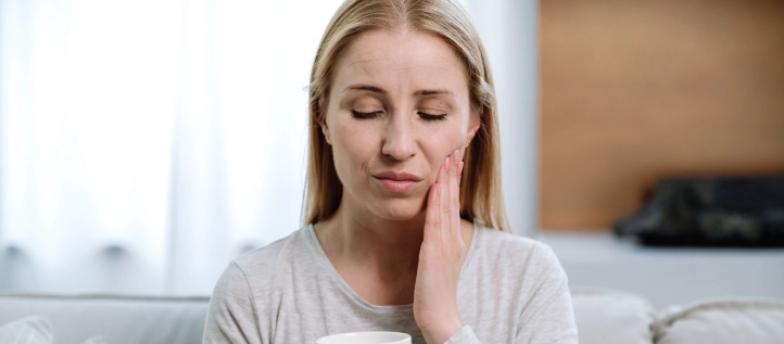 Young woman having mouth pain