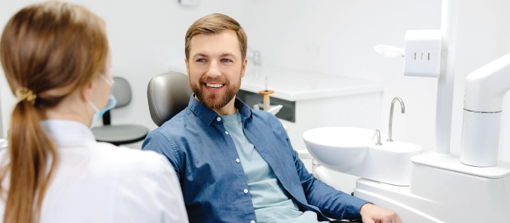 Male patient sitting on a chair at the dentist