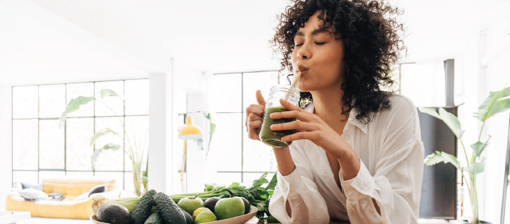 A young woman drinking a smoothie