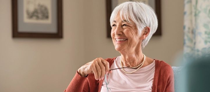 Senior woman sitting on the couch smiling